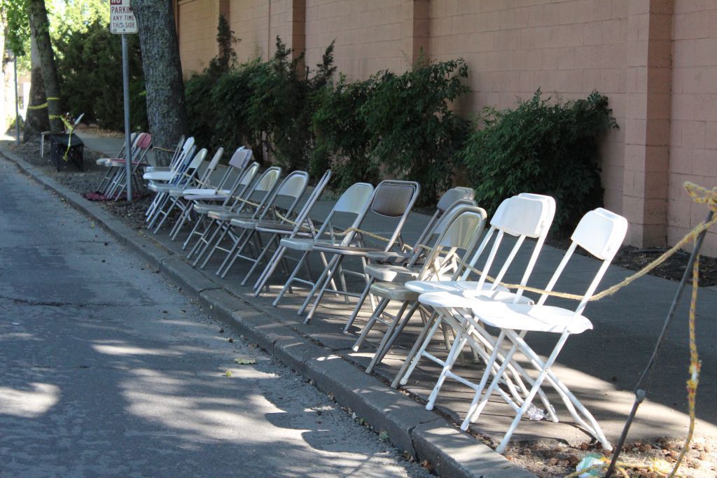 Folding chairs placed on the sidewalk pre-parade